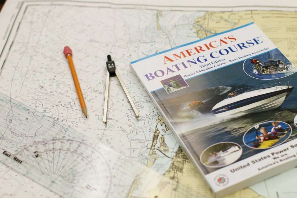 America's Boating Course materials on a nautical chart with navigation tools