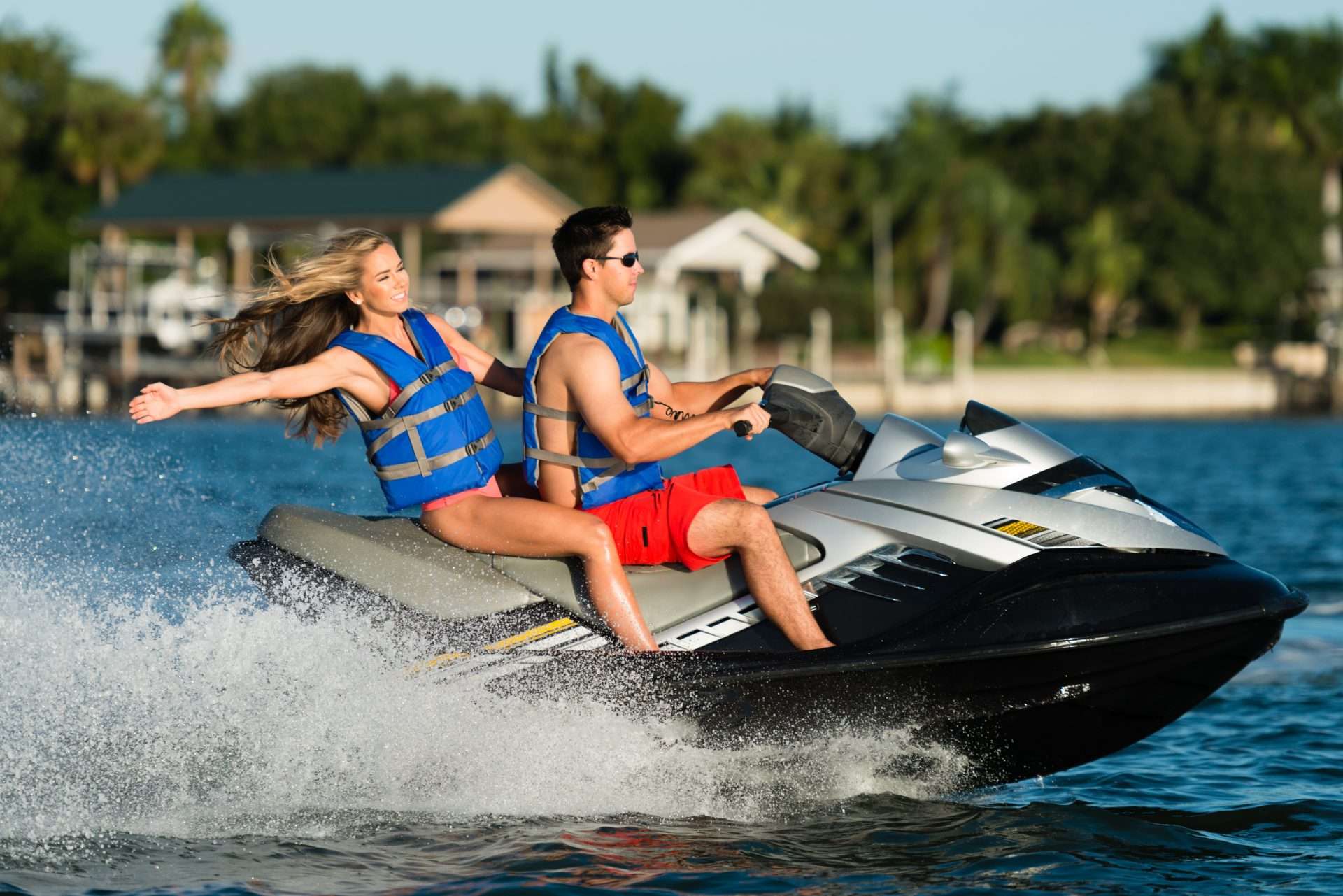 Two people riding a personal watercraft on the water near Clearwater