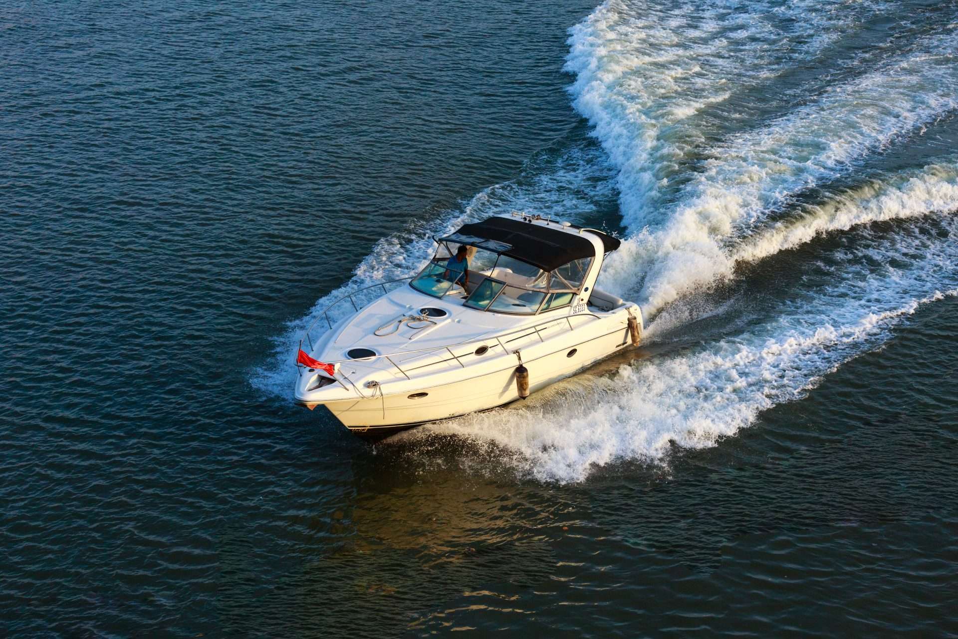 Speedboat creating a wake on open water